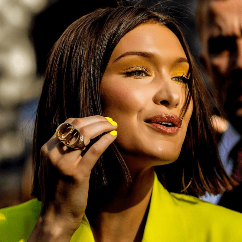 Bella Hadid wears a sleek bob hairstyle and yellow eyeshadow