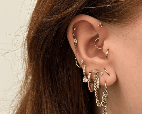 An ear with multiple piercings including the tragus