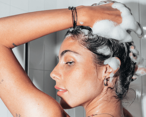 Close up of the side of woman's face as she washes her hair